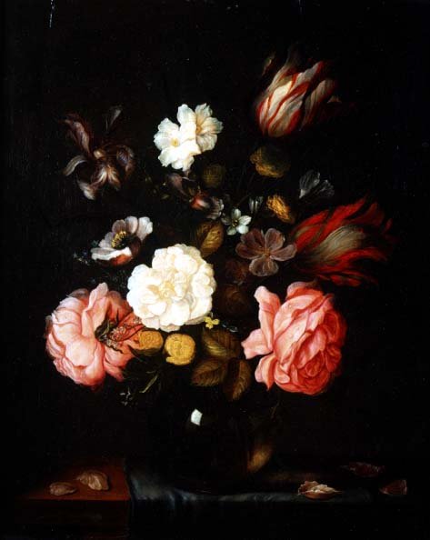 Flowers in a glass vase on a draped table