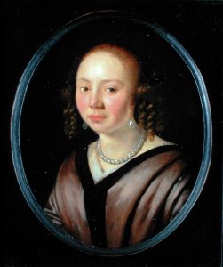 Portrait of a young woman wearing a necklace and earrings