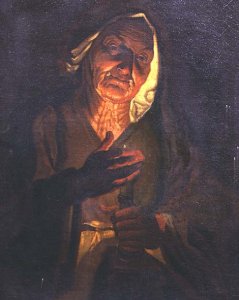 An old woman holding a candle