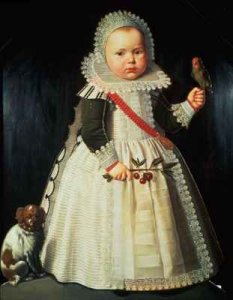 Portrait of a young boy holding a parrot